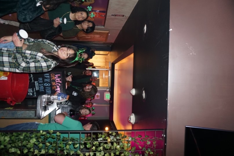 Guests entering Hookava during a Crawl Reno St. Patrick's Day event with welcome sign
