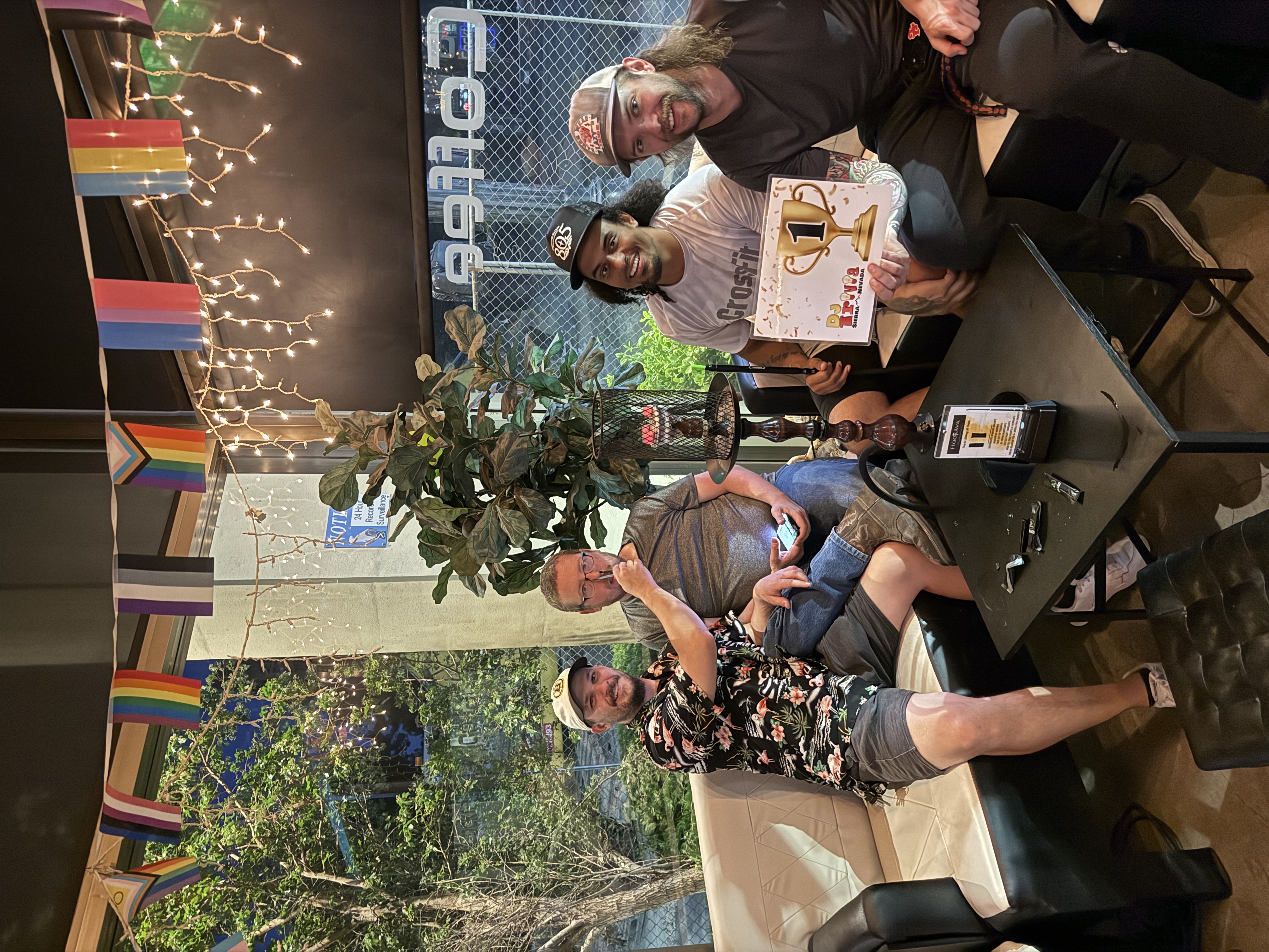 1st place trivia winners holding trophy card at Hookava