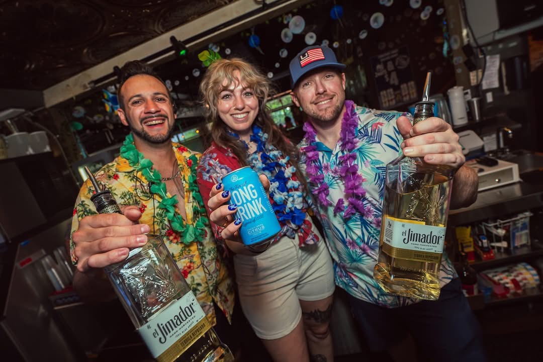 Hookava staff and guests in tropical gear celebrating a Crawl Reno event