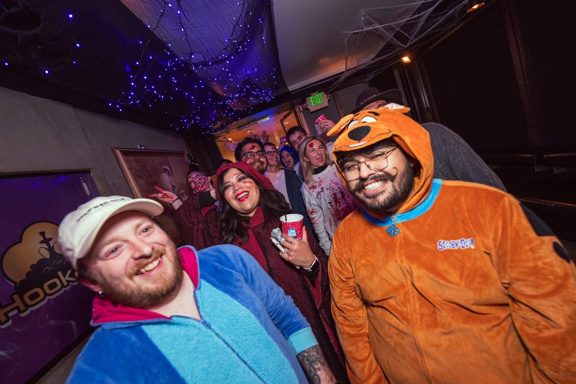 Group of costumed guests at Hookava during Zombie Crawl with Scooby-Doo onesie and Halloween costumes