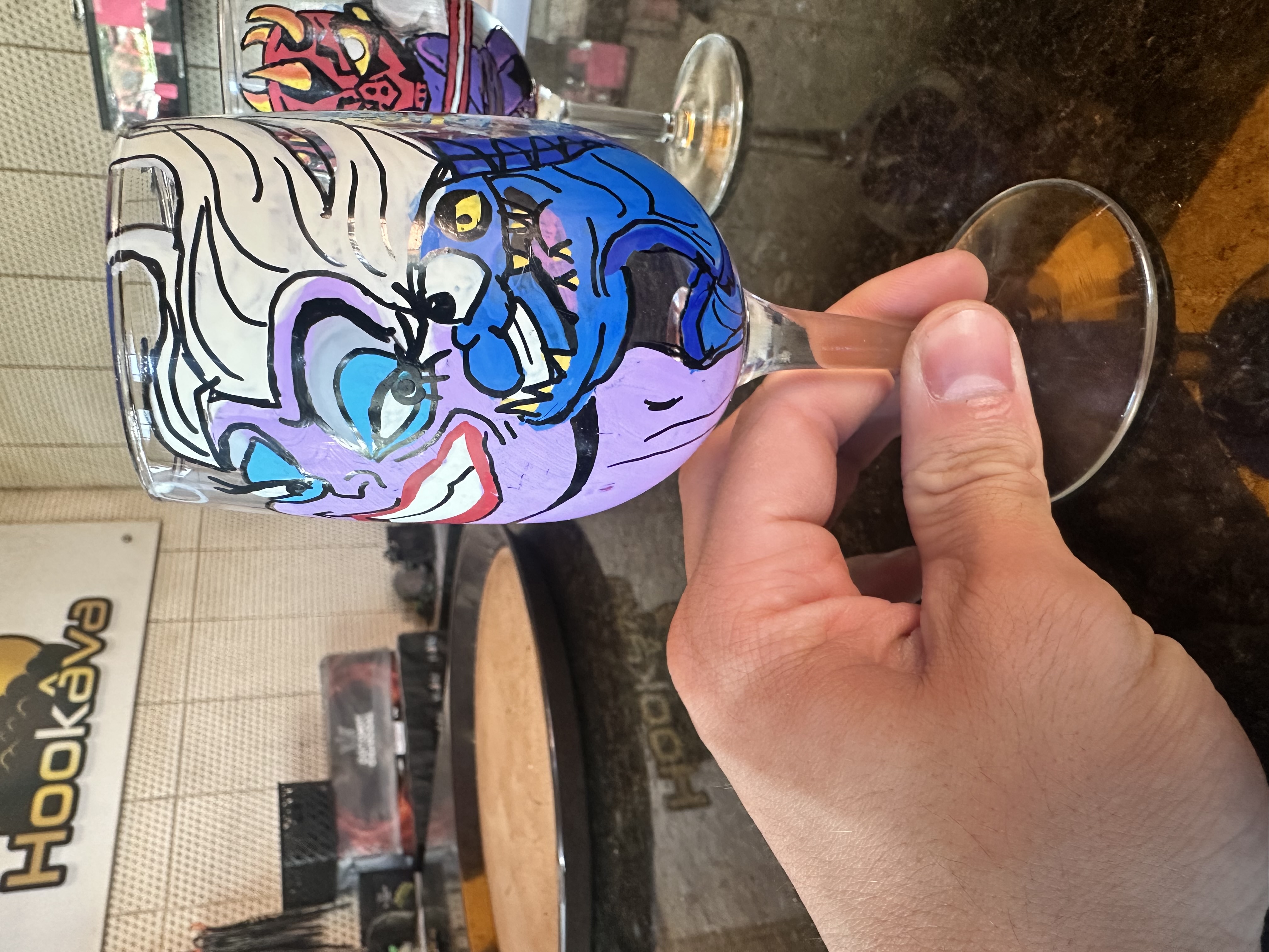 Hand-painted abstract art wine glass at Hookava bar