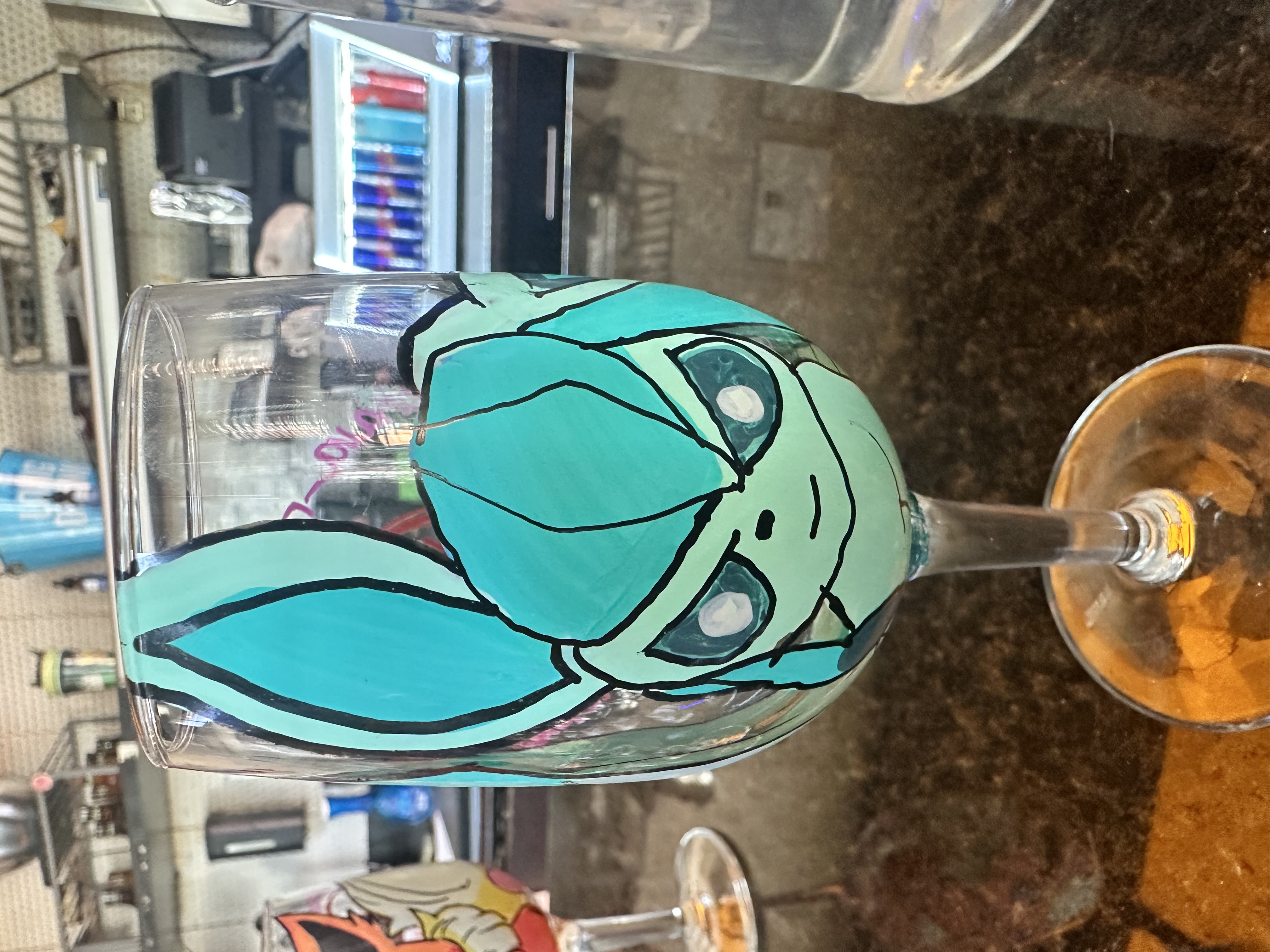 Hand-painted Ursula villain wine glass held at Hookava